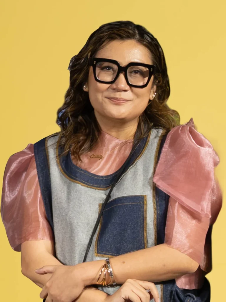 Angel Romero, Director for Advocacy and Partnerships, wearing glasses and a stylish top