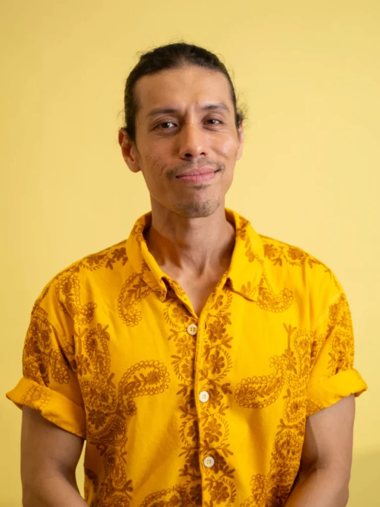 Atty. Joaquin Reyes, Legal Counsel, wearing a patterned yellow button-up shirt
