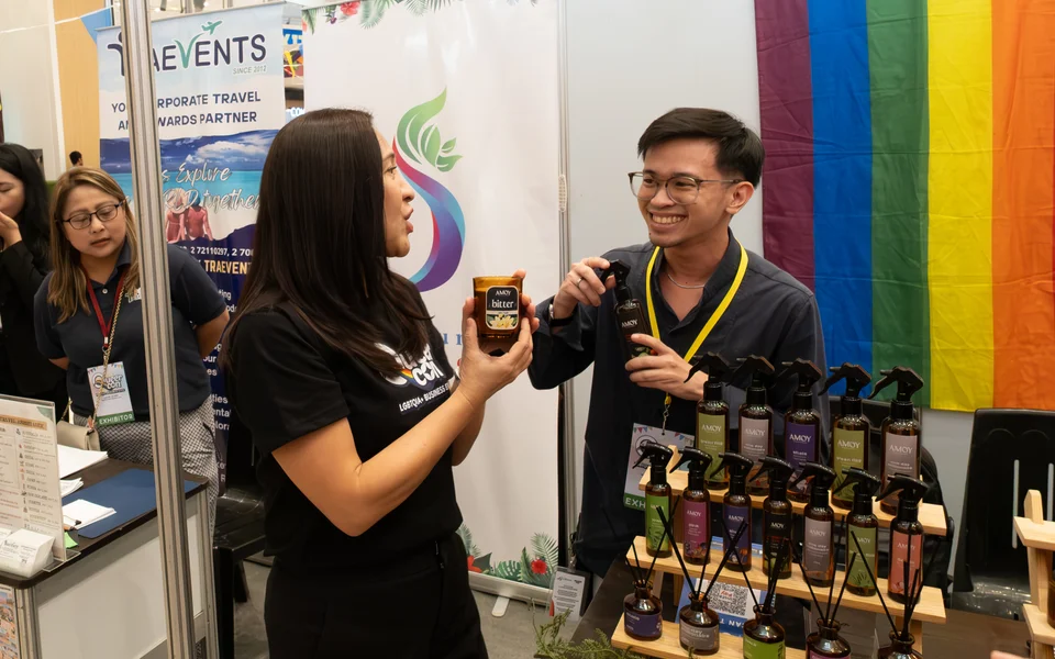 Quezon City Mayor Joy Belmonte smiling while interacting with an exhibitor at an indoor market stall.